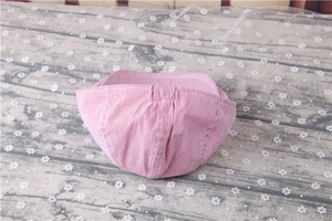 Detailed back view of pink striped baby beret showing the elastic band and breathable fabric