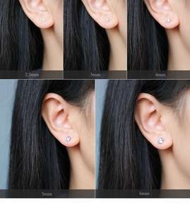Detailed comparison of silver stud earrings in 2.5mm to 6mm sizes on model ear