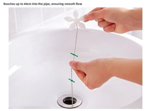 Detail of 44cm sink drain hair remover tool being inserted into bathroom basin drain