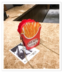 Close-up of creative French Fries chain bag with red and yellow PU leather and golden strap