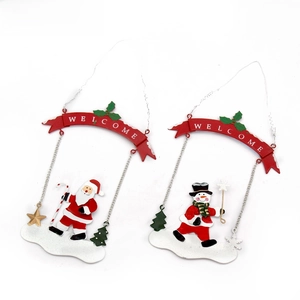 Detail of painted metal Christmas ornaments with Santa Claus and Welcome banner