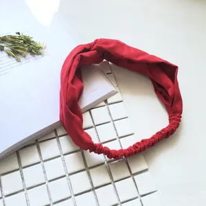 Macro shot of a red twisted elastic headband with soft texture and chic knotted design