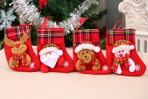 Detail of red Christmas stockings featuring 3D Santa, Reindeer, Bear, and Snowman figures