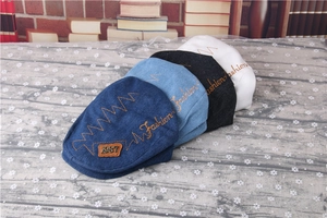 Close-up of children's striped beret hats in multiple colors with fashion embroidery