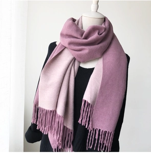 Detail of soft pink and purple cashmere-style scarf with fringe on a mannequin
