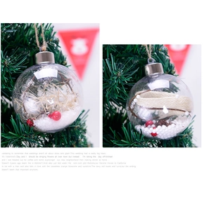 Detail of 8cm clear Christmas ball ornaments with berries and snow inside hanging on a tree