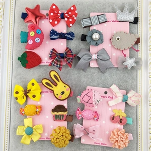 Detailed set of cute girls hair clips with bows, strawberries, and sparkling crowns on cards