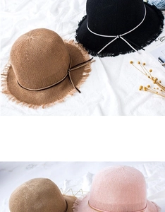 Detailed close-up of woven straw hats featuring fringe brims and decorative bows