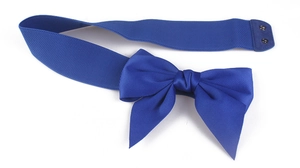 Detail of royal blue elastic waist belt with large satin bow and secure metal snap buttons
