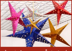 Detailed view of colorful laser hollowed-out paper star lanterns for Christmas decor