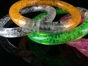 Close-up of colorful LED bubble bracelets with clear acrylic texture and toggle switches