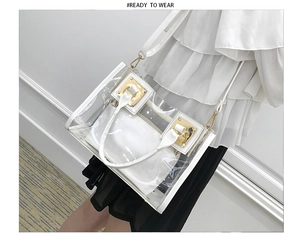 Detail of white transparent jelly bag with golden buckle on a shoulder strap