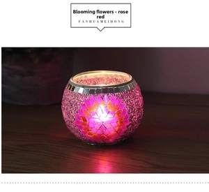 Detail of European mosaic glass candle holder with blooming magenta flower patterns