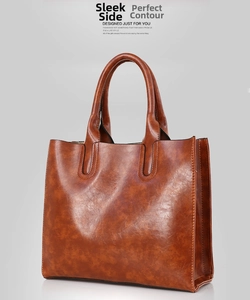 Detailed side view of the brown oil wax leather tote bag showing the structured profile
