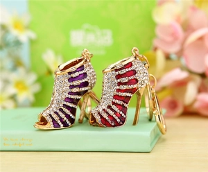 Detail of creative high heel keychains featuring purple and red rhinestones on gold chain