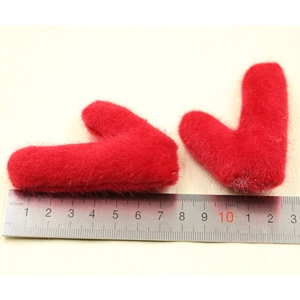 Detail view of plush red deer antler hair accessories with a ruler showing the 6-7cm width