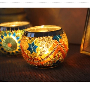 Close-up of handmade mosaic glass candle holder with vibrant geometric patterns
