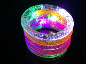 Close-up of colorful glowing LED acrylic bracelets with air bubbles for party favors