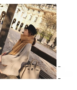 Detail of soft camel mohair scarf with chunky knit texture paired with a grey sweater