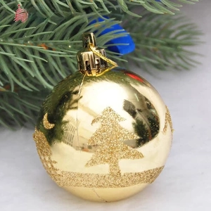 Detailed view of 6cm golden Christmas ball featuring sparkling pine and moon patterns