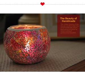 Detail of handmade mosaic glass candle holder with warm pink and purple glow