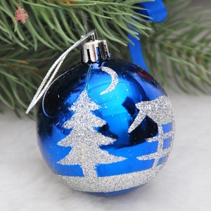 Detailed view of blue Christmas ball with silver glitter pine tree and moon patterns