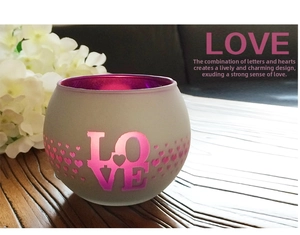 Detail of frosted mosaic glass candle holder with LOVE letters and heart shaped cutouts