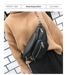Detail of black multi-pocket PU leather chest bag with heavy duty silver metal chains