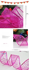 Detail of rose red organza ribbon with silver glitter spiral pattern for gift wrapping