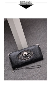 Detailed view of punk skull ornament and silver corners on black faux leather long wallet