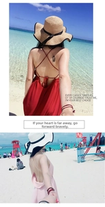 Detailed back view of a wide-brim straw hat with black bow and pink beach dress