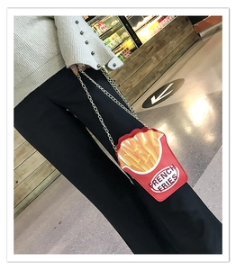 Creative french fries shaped crossbody bag with gold chain strap shown on a person