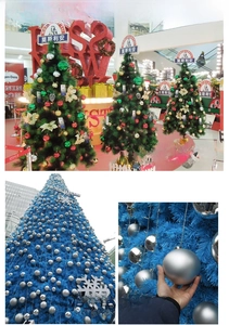 Detail view of glossy and matte silver Christmas ball ornaments on a decorated pine tree