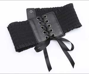 Close-up detail of the black wide elastic corset belt with front lace-up ribbon bow.