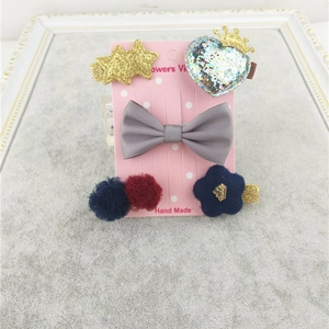 Detail view of 4-piece cute children hair clip set with stars, crowns, and mink fur bows