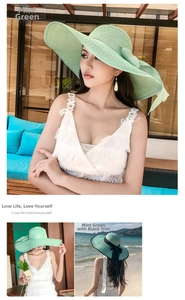 Detail showing mint green straw hat with large brim and matching oversized bow decoration