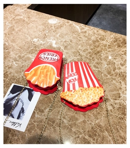 Close-up of creative French fries and popcorn shaped shoulder bags with gold chains
