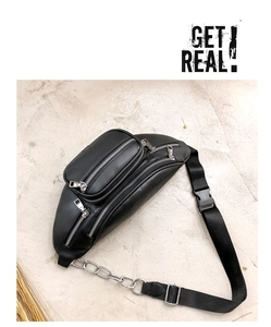 Detail of black PU leather waist bag with silver zippers and stylish metal chain strap