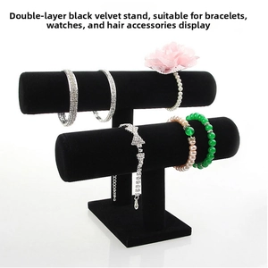 Macro detail of a 2-tier black velvet jewelry stand for bracelets and watches