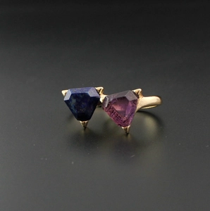 Detailed macro view of golden ring featuring triangle-cut amethyst and lapis lazuli stones