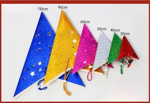 Flat lay of laser-cut paper star lampshades in multiple colors and varied sizes