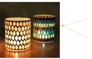 Close-up of mosaic glass candle holders with leaf and geometric patterns in warm light