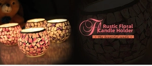 Close-up of pink floral mosaic glass candle holder with warm glowing light effect