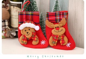 Detail of Christmas stockings with 3D bear and reindeer figures on a cozy festive table