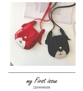 Detail view of cute bunny-shaped mini shoulder bags with embroidered faces and golden buckles