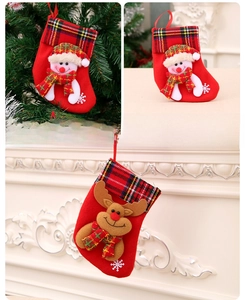 Detail of red Christmas stockings featuring snowman and reindeer with plaid trim