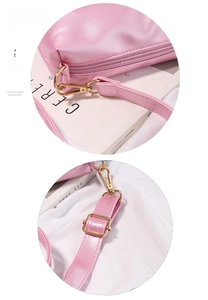 Detail of pink jelly bag showing gold metal zipper and adjustable shoulder strap buckle