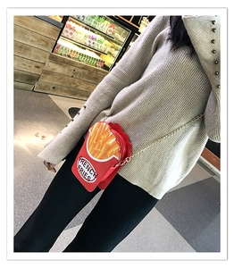 Creative french fries crossbody bag with red PU shell and gold chain strap shown on person