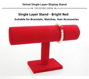 Detail of red velvet T-bar display stand holding a white pearl bracelet on white background