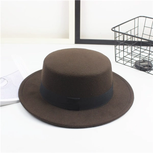 Detailed shot of dark brown flat top wool fedora hat with black grosgrain ribbon band